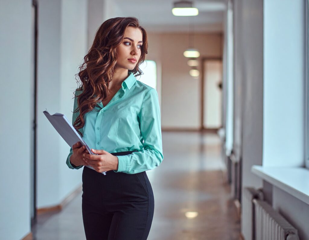 firefly create a image of girl stand with some papers in formal light green shirt and black p 286336